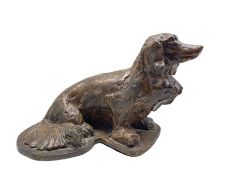 Bronze of a seated spaniel