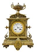 French brass cased mantle clock c1880 with a domed pediment surmounted by a twin handled urn