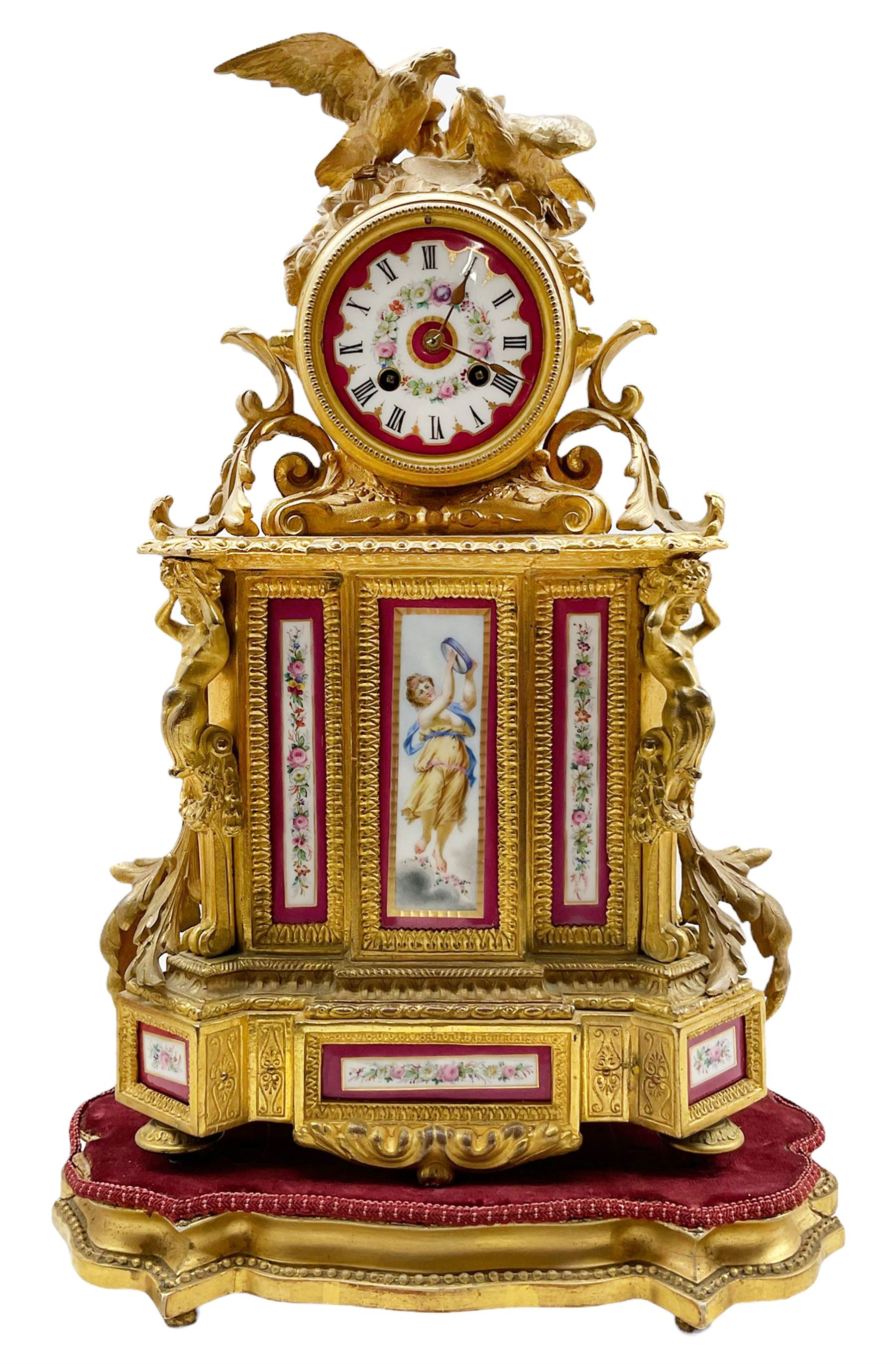 French Napoleon III mantle clock in a gilt speller rococo case surmounted by two birds taking flight