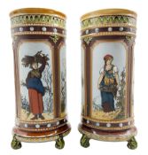 Pair of Mettlach cylindrical stoneware vases decorated with panels of female figures in pastoral lan