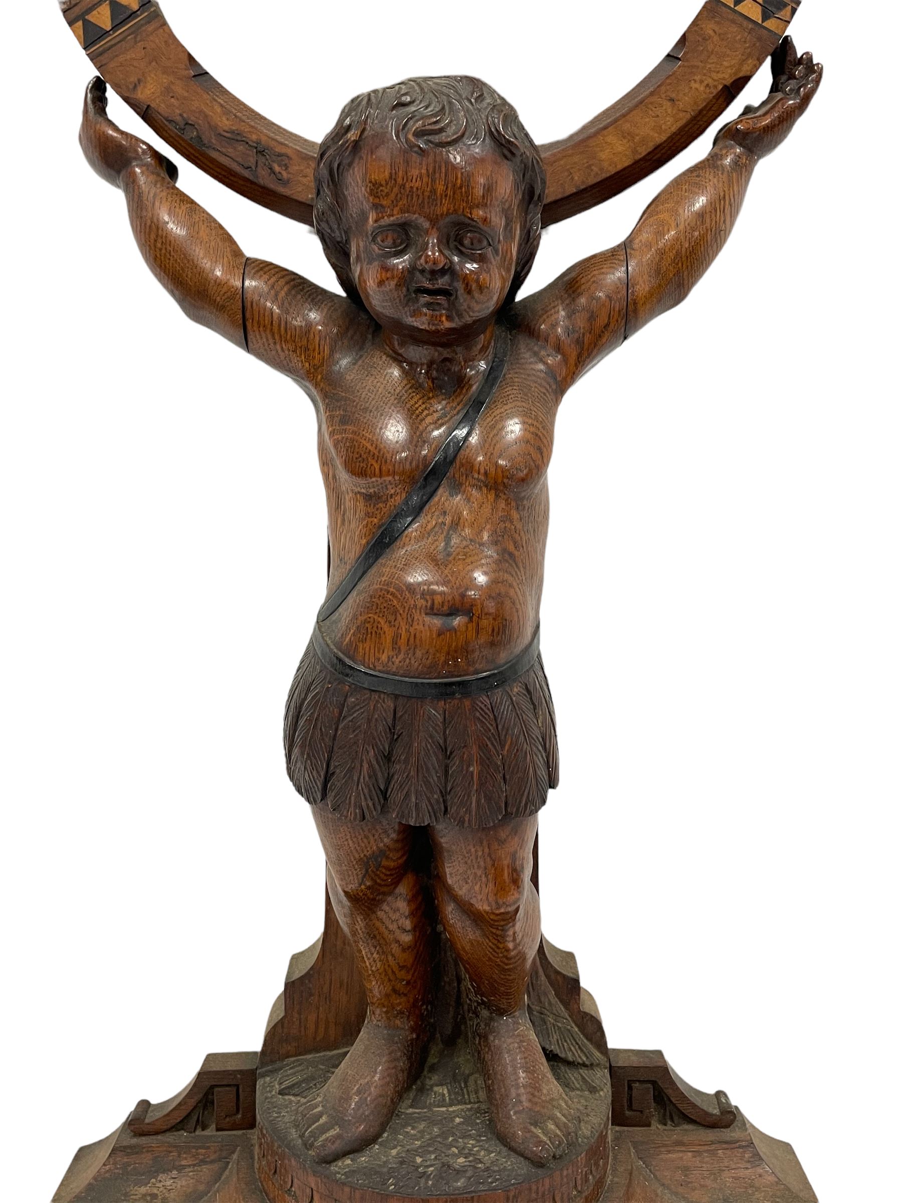 Victorian carved oak gong stand in the form of a Cherub supporting a circular walnut frame with cent - Image 4 of 5