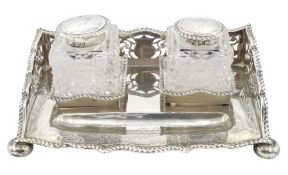 Late Victorian silver inkstand of serpentine outline with three quarter pierced gallery fitted with