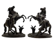 After Guillaume Coustou (1677-1746): Pair of spelter Marly horses with their groom