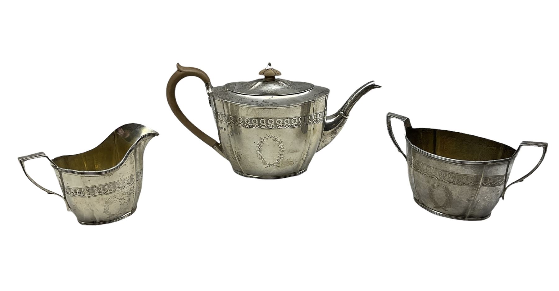 Three piece silver tea set of oval design with engraved decoration and cartouche London 1934 Maker C