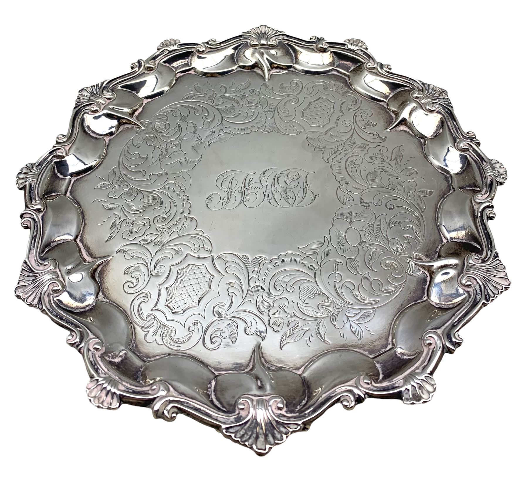 Victorian silver small salver engraved with leaves and monogram within a shell moulded border on sha