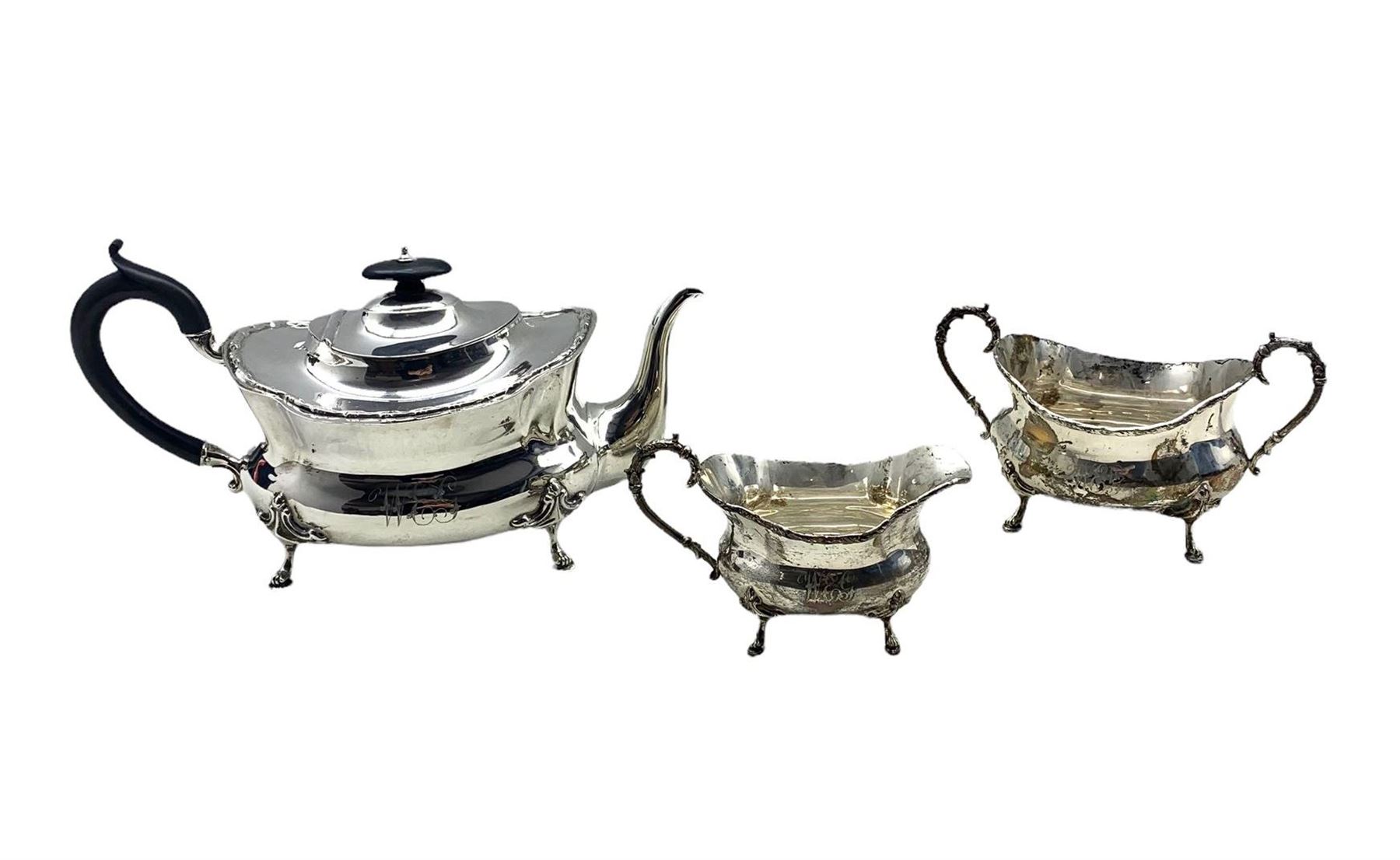 Edwardian silver three piece tea set of oblong form engraved with monogram