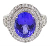 18ct white gold oval tanzanite and two row round brilliant cut diamond cluster ring
