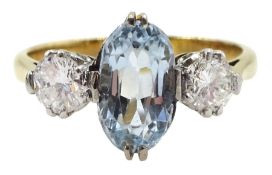 Gold three stone oval aquamarine and round brilliant cut diamond ring