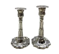 Pair of Edwardian silver candlesticks with leaf moulded sconces and shaped bases by Williams Ltd