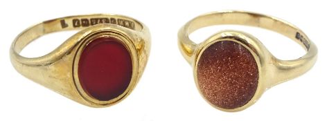 Gold single stone carnelian ring and a single stone goldstone ring