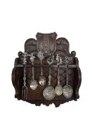 Small oak spoon rack with six Dutch spoons and fork