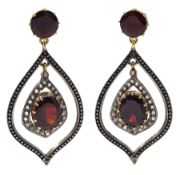 Pair of tear drop shaped oval and round garnet and diamond set pendant earrings