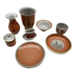 Nine pieces of Royal Copenhagen orange crackle glazed pottery comprising two vases