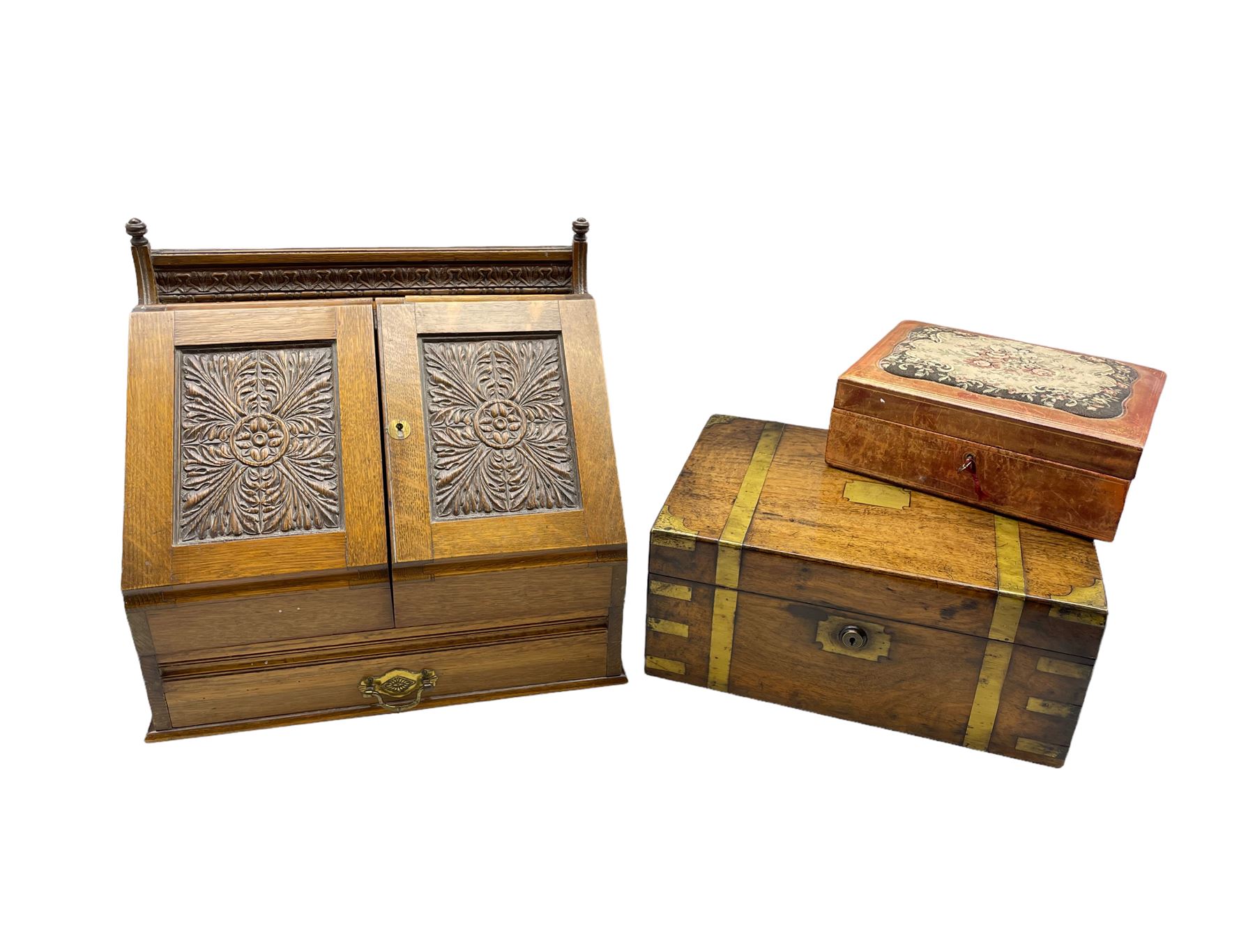 Edwardian oak correspondence box with two panelled doors carved with acanthus leaves below a raised