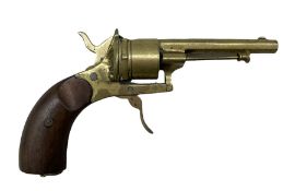 Novelty brass cigar cutter in the form of a revolver pistol with walnut grip