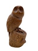 Carved oak model of an Owl standing on a naturalistic rocky base