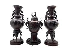 Pair of Japanese bronze baluster two handled vases with a raised pattern of birds and flowers H38cm