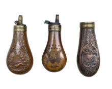 Three copper pistol powder flasks with embossed bodies