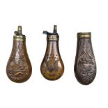 Three copper pistol powder flasks with embossed bodies