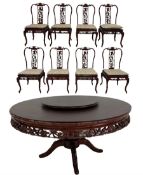 Circular rosewood dining table over one turned pillar leading into four splayed supports