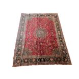 Persian rug with overall floral motifs on a red field and navy border 290cm x 400cm