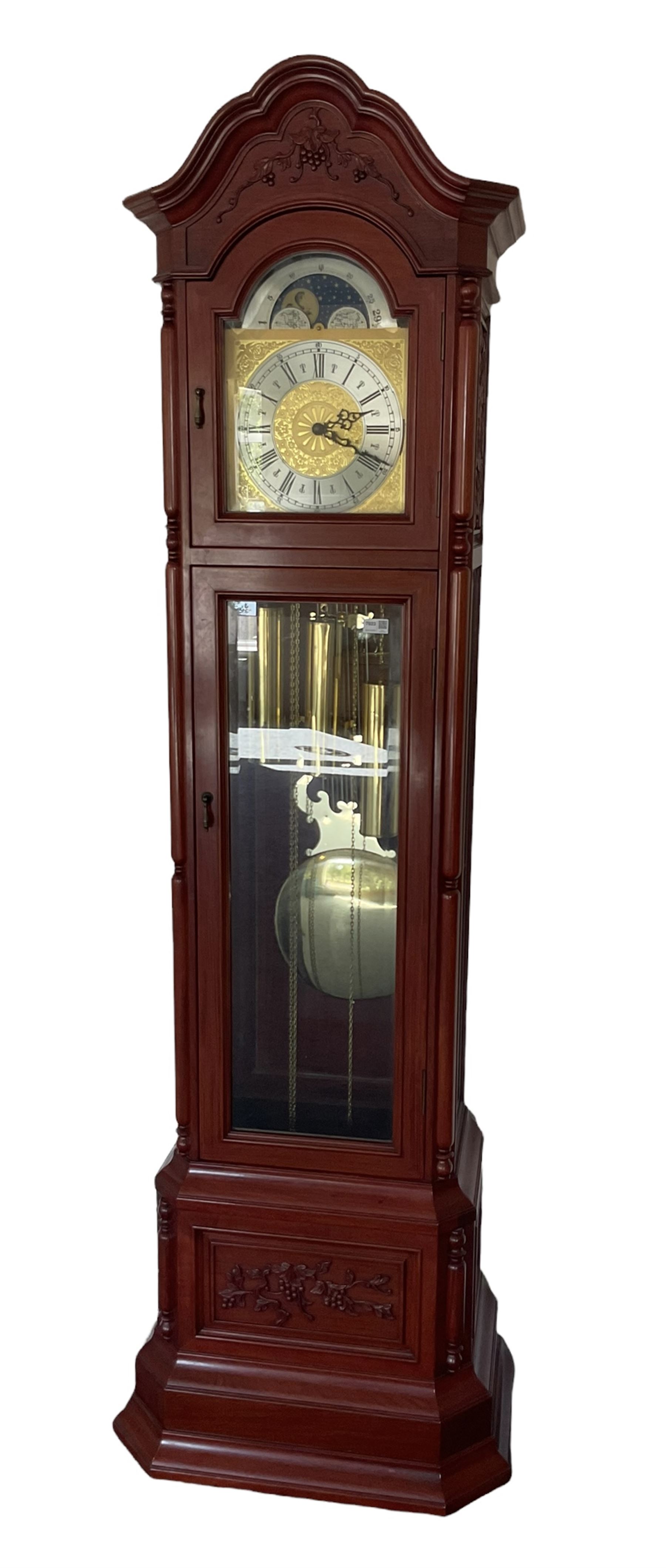An impressive 20th century longcase clock in a mahogany case with an arched pediment