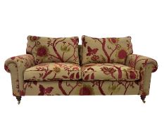 Duresta - two seat sofa upholstered in embossed floral fabric with footstool