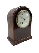An Edwardian mahogany mantle clock with a break arch top
