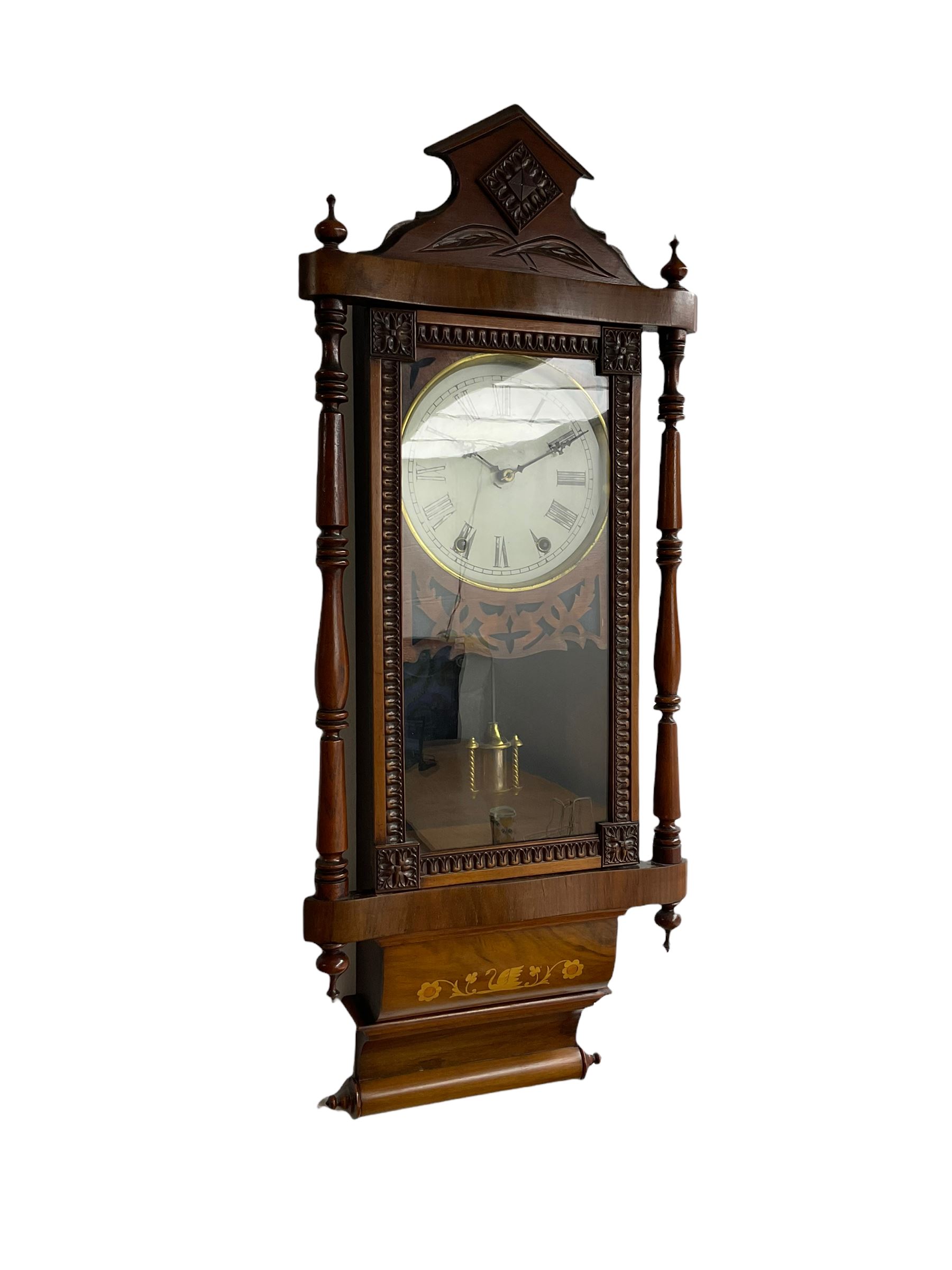 A 19th century American wall clock manufactured by the “New Haven” clock company, in a mahogany