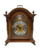 A contemporary German replica of an 18th century style bracket clock in a light mahogany break arch