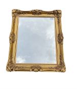 Rectangular wall mirror in embossed gilt frame