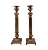 Pair of copper finish candlesticks with reeded stems and square bases