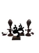 Pair of carved oak dragons on bases; together with pair of wooden carved 'lotus' lamps