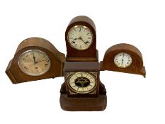 Four wooden cased mantle clocks