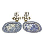 Pair of brass two branch candelabra with prism drops H30cm together with two Willow pattern meat pla