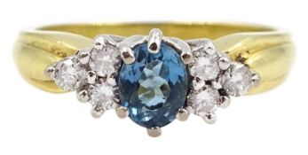 18ct gold oval blue topaz and six stone round brilliant cut diamond cluster ring