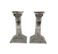 Pair of Edwardian silver Corinthian column candlesticks with stepped square bases H15cm Sheffield 19