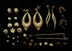 Nine pairs of 9ct gold earrings including embossed floral pendant stud earrings