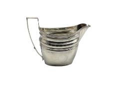 George III silver cream jug decorated with an engraved hatched band and with vacant cartouche and re