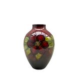 Walter Moorcroft Clematis pattern flambé vase on a deep red ground