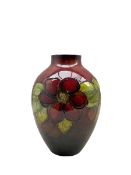 Walter Moorcroft Clematis pattern flambé vase on a deep red ground