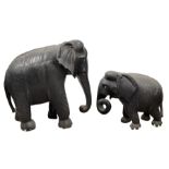 Large Indian carved and ebonised wood elephant H66cm x L64cm and a smaller similar elephant H38cm x