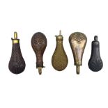 Five copper and brass powder flasks including two by Sykes Patent