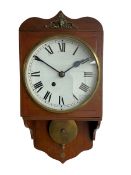 An early 20th century wall clock in a mahogany case