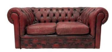 Two seat Chesterfield sofa upholstered in buttoned red leather