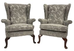 Pair of wingback armchairs upholstered in light grey fabric