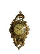 A mid 20th century wooden gilt painted cartel clock in the French 18th century Rococo style