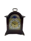 Compact late 20th century German Westminster chiming mantle clock in a break arch mahogany effect ca