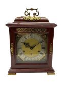 A 20th century replica 17th century bracket clock with an inverted bell top and applied brass castin