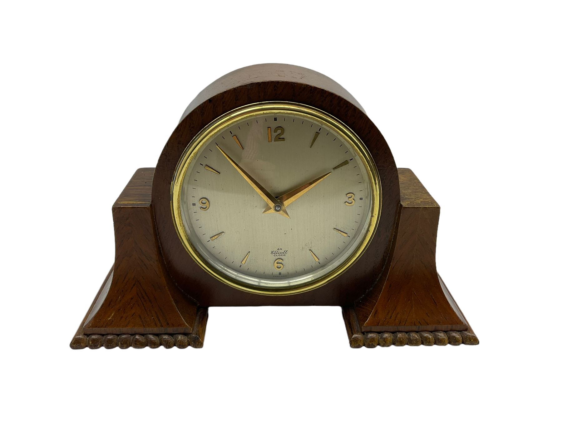 A small mid-20th century English made mantle clock in a round oak case with protruding side supports